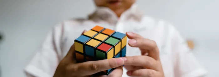Child holding a Rubiks cube